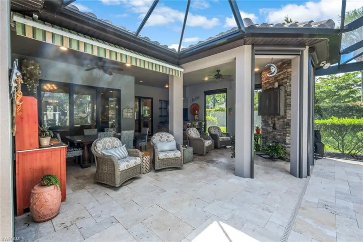 View of patio / terrace featuring ceiling fan and a lanai