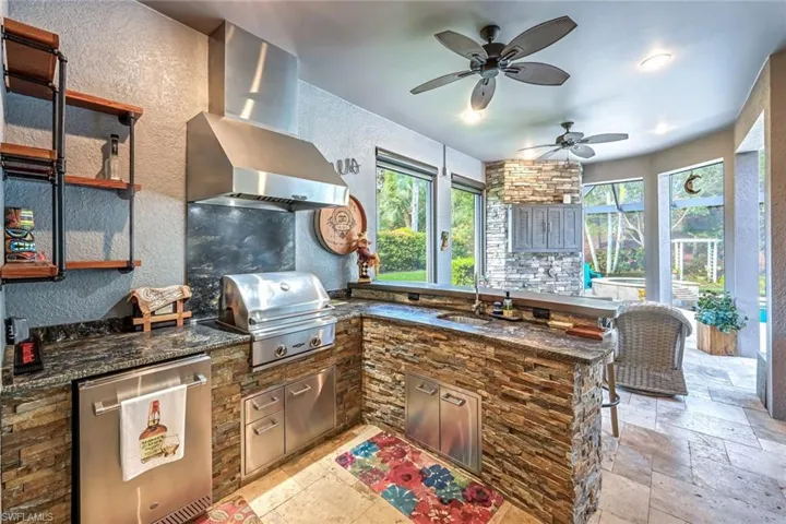 View of patio / terrace with a ceiling fan and area for grilling