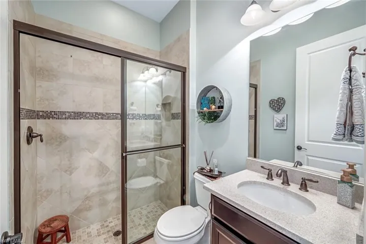 Bathroom featuring vanity and a shower stall