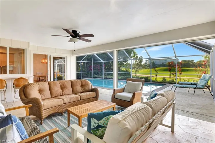 Lanai featuring ceiling fan and a pool