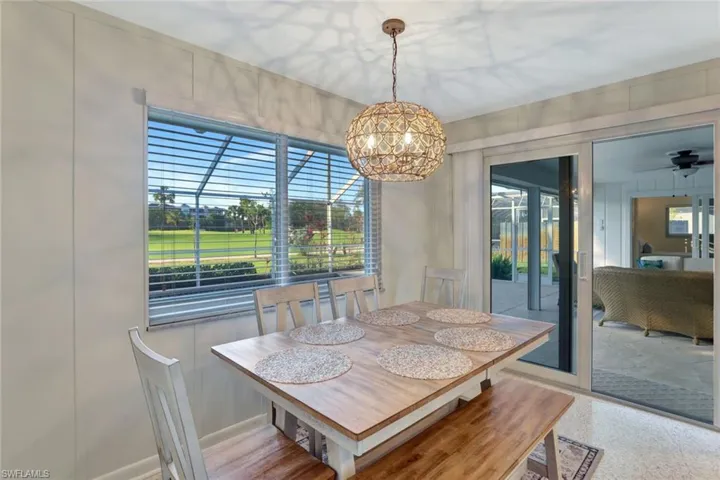 Dining area with ceiling fan with notable chandelier