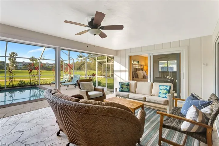 Lanai featuring ceiling fan, a healthy amount of sunlight, and a pool