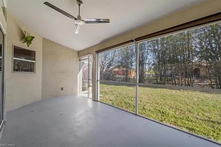 Unfurnished sunroom with a ceiling fan and lofted ceiling