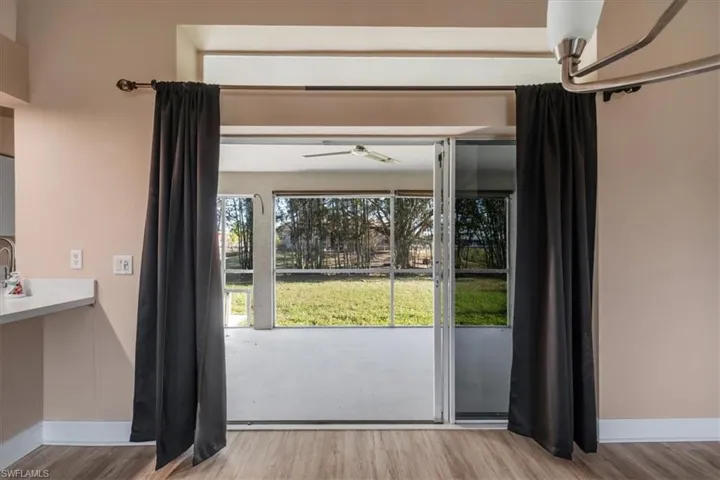 Entryway with wood finished floors and ceiling fan