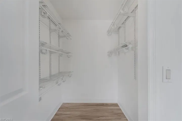 Spacious closet with light wood-style floors