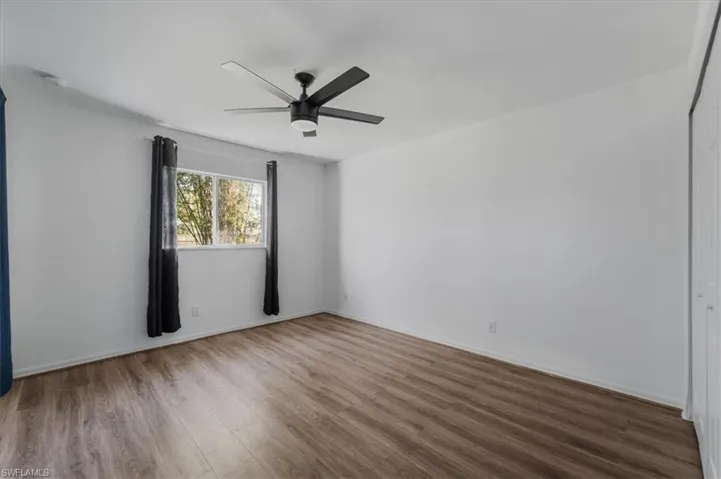 Spare room featuring wood finished floors and a ceiling fan