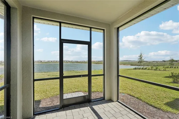 Unfurnished sunroom featuring a water view