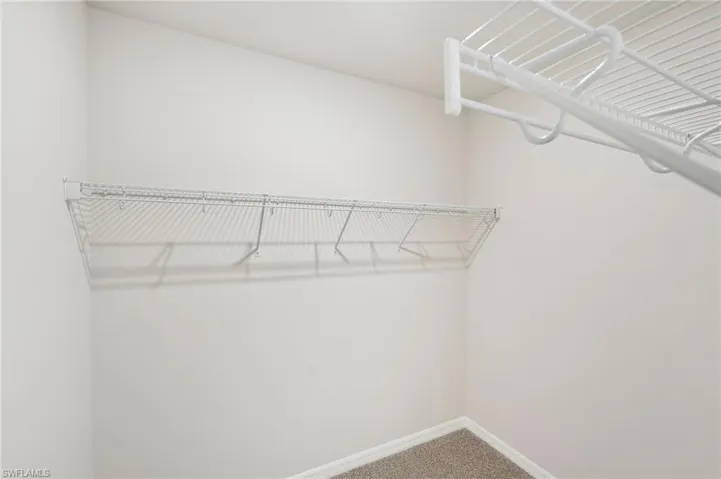 Walk in closet featuring carpet flooring