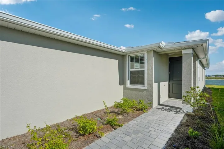 View of exterior entry featuring stucco siding