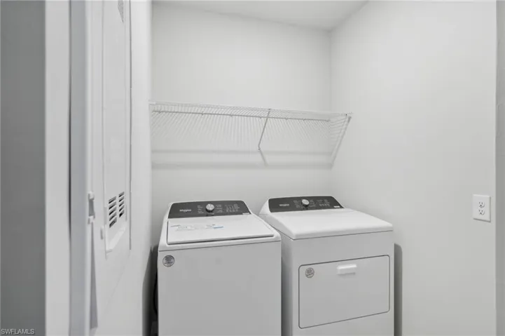 Laundry room featuring separate washer and dryer and laundry area