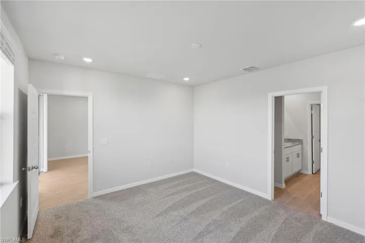 Unfurnished bedroom featuring visible vents, baseboards, and recessed lighting
