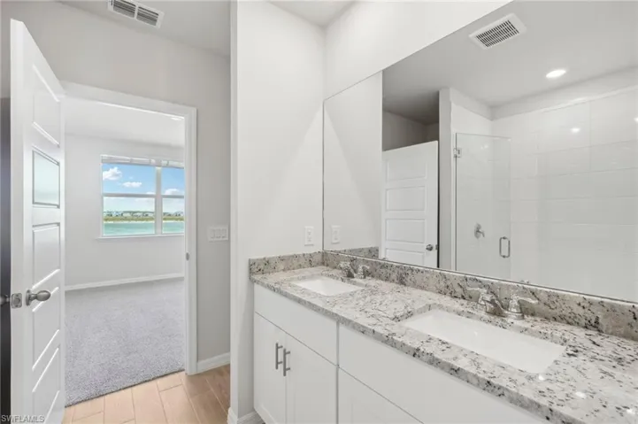 Full bathroom with a shower stall, visible vents, and a sink