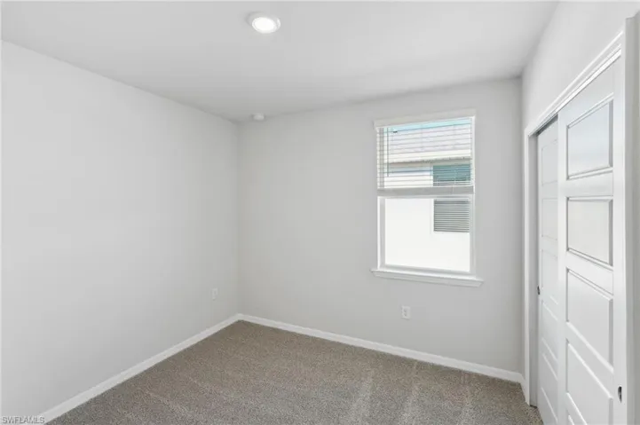 Spare room featuring recessed lighting, baseboards, and carpet floors