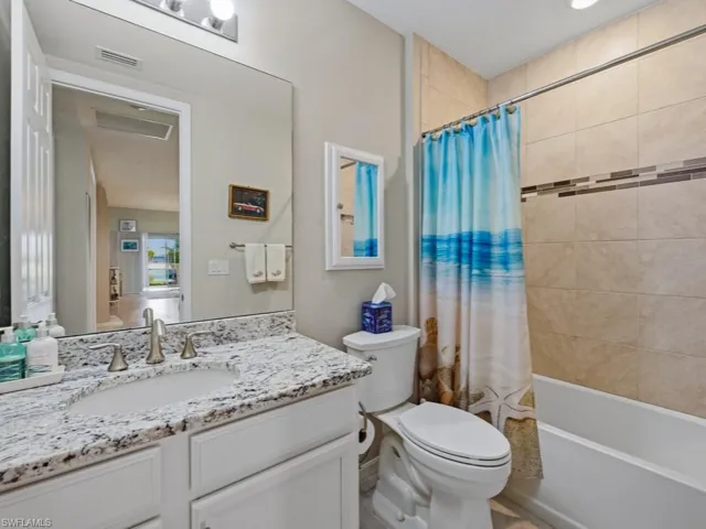 Full bathroom with shower / tub combo and vanity