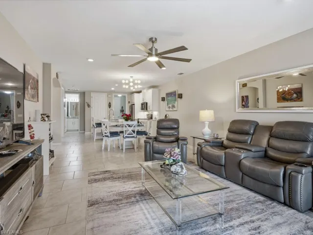 Living area with ceiling fan, recessed lighting, and light tile patterned floors
