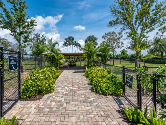 View of community two dog parks (large and small dogs) with a gate, a patio area, and a gazebo