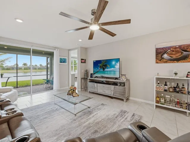 Living room featuring light tile patterned floors, a ceiling fan, tv stand and LG TV