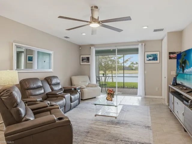 Living room with ceiling fan and recessed lighting and view of lake