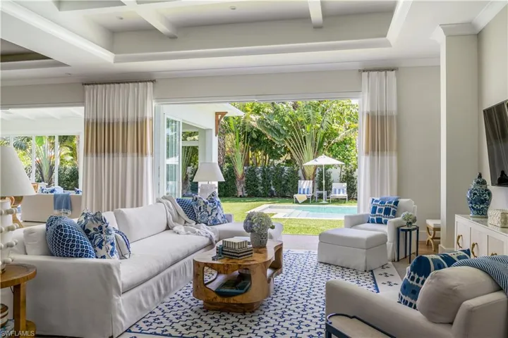Living room featuring healthy amount of natural light, beam ceiling, and coffered ceiling