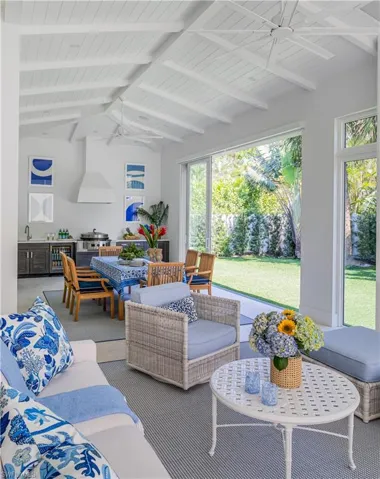 Sunroom / solarium featuring wine cooler and a sink
