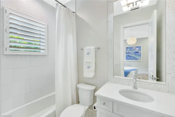 Ensuite bathroom featuring shower / bath combo and vanity