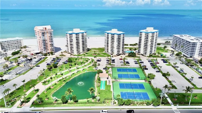 Large 3 building complex with pickle ball, tennis, water feature and more.