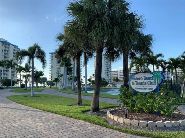 Entrance to complex tall palms line the drive.
