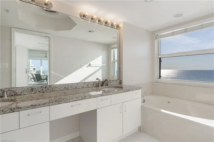 Full bath with a garden tub, tile patterned floors, visible vents, and vanity