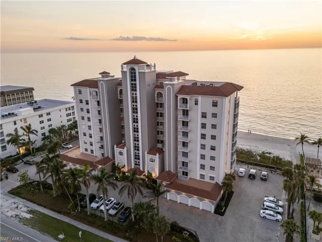 View of property featuring a view of the beach and a water view