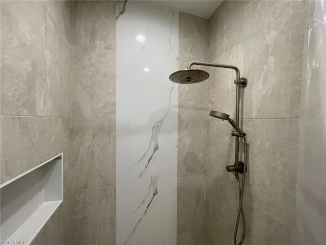 Full bathroom featuring a tile shower