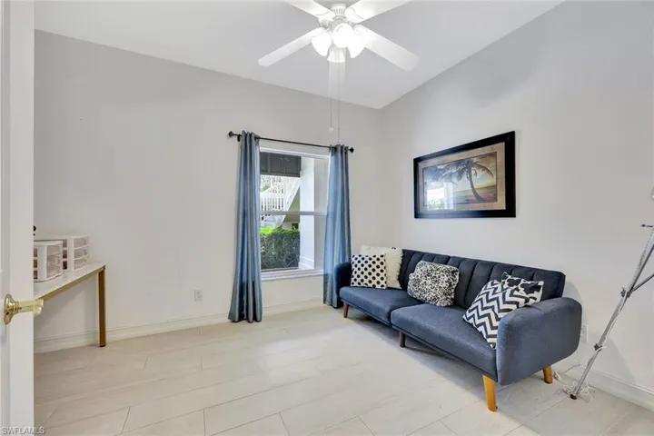 Living room featuring a ceiling fan and light wood-style floors