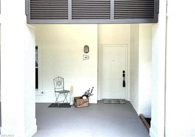 Property entrance with stucco siding