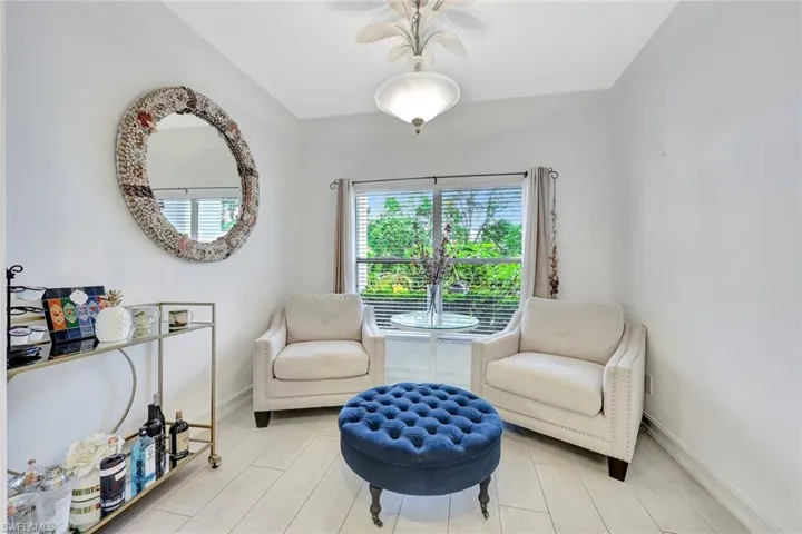 Sitting room featuring a ceiling fan and baseboards