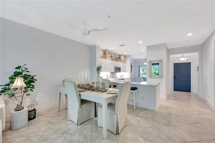 Dining room featuring light tile patterned floors and recessed lighting