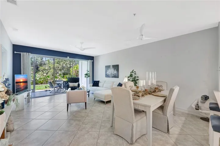 Dining space featuring ceiling fan and light tile patterned flooring