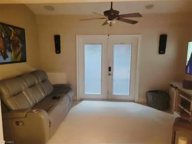 Living area featuring french doors and ceiling fan