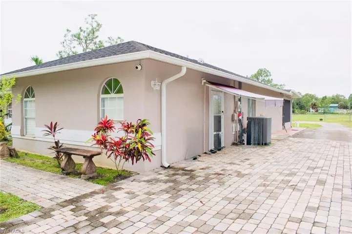 View of property exterior featuring stucco siding and a cooling unit