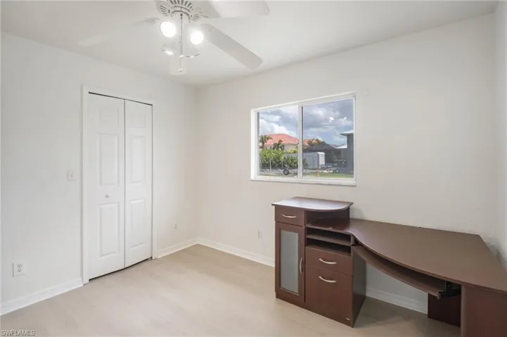 Light-toned wood-finish flooring complements the crisp white walls and bi-fold closet doors
