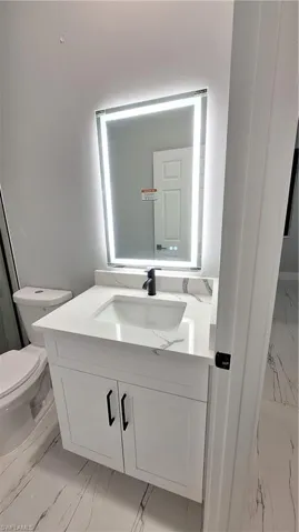 Bathroom with toilet and vanity