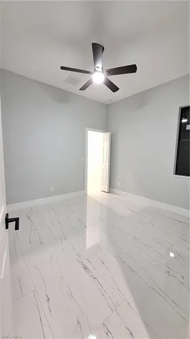 Unfurnished room featuring ceiling fan