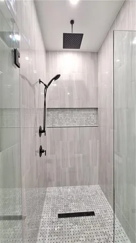 Bathroom featuring a tile shower