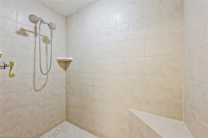 Ensuite primary bathroom features a large walk-in shower with a bench.