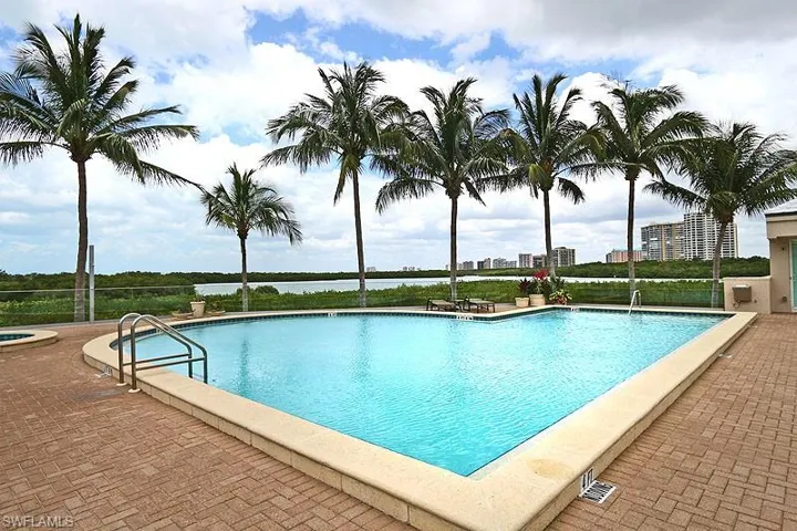 Geometric swimming pool with paver decking and integrated spa