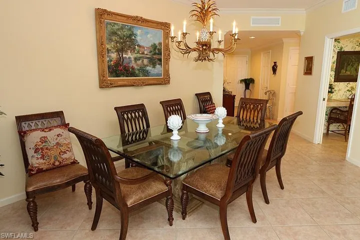 Dining area featuring neutral wall tones and large format tile flooring