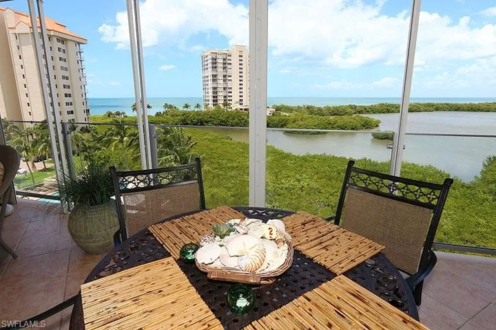 Outdoor patio with tile flooring and a glass railing system