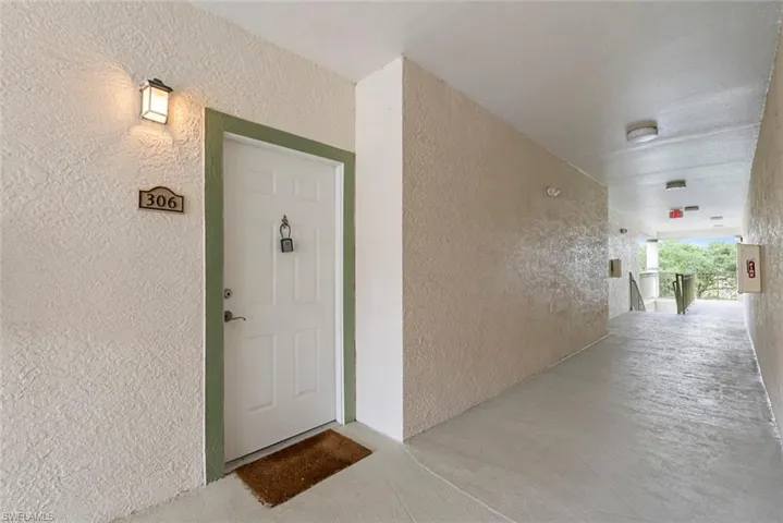 View of exterior entry featuring stucco siding