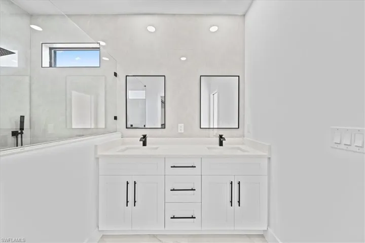 Bathroom featuring double vanity and walk in shower