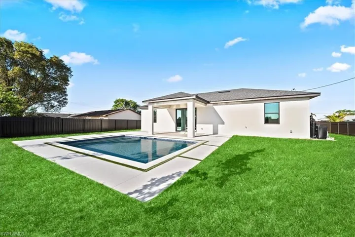 Back of house with a fenced backyard, a patio, and stucco siding