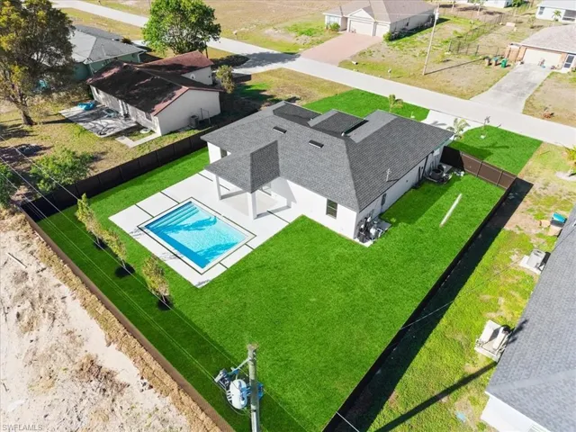 Aerial perspective of suburban area with a pool area