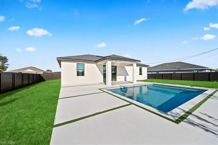 View of pool featuring patio surround and a fenced backyard
